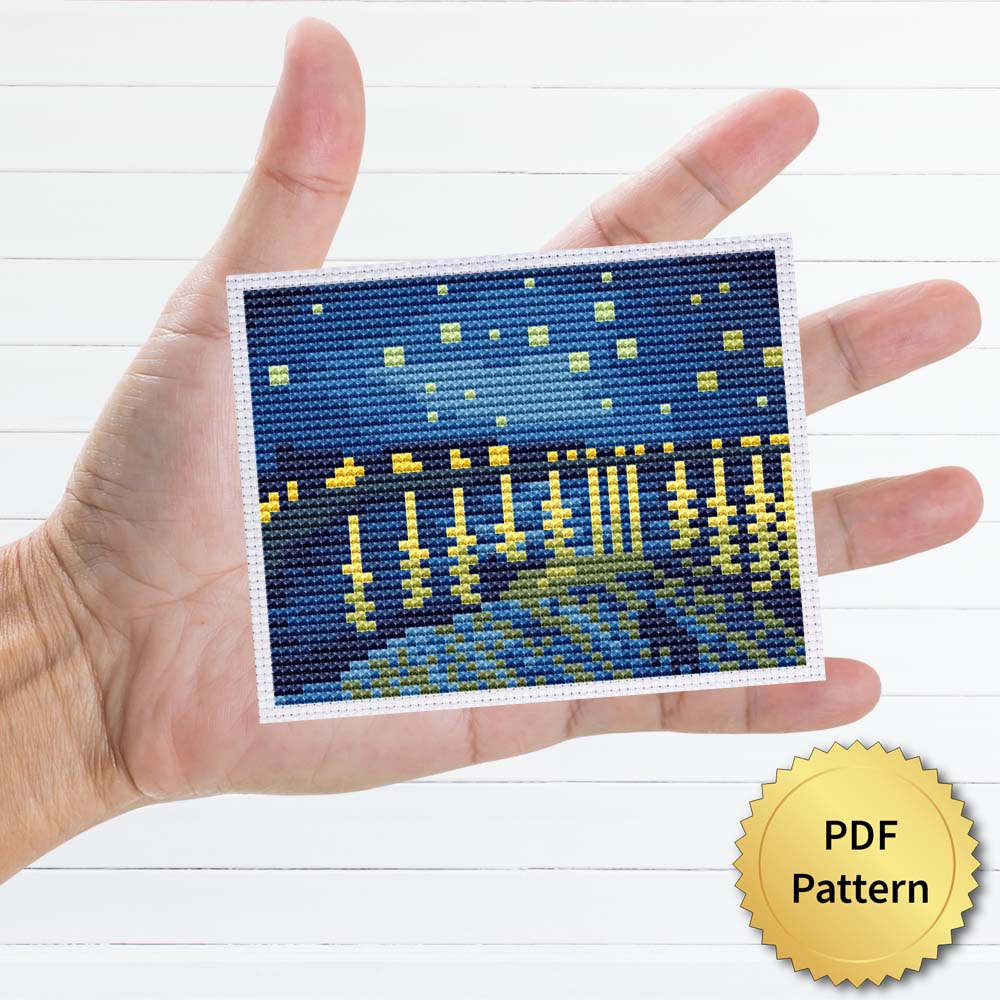 Starry Night Over the Rhone cross stitch pattern featuring a stunning reproduction of the famous Vincent van Gogh painting