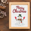 Christmas Snowman Cross Stitch Pattern - Image of a finished cross stitch project with a cute snowman wearing a hat and scarf.